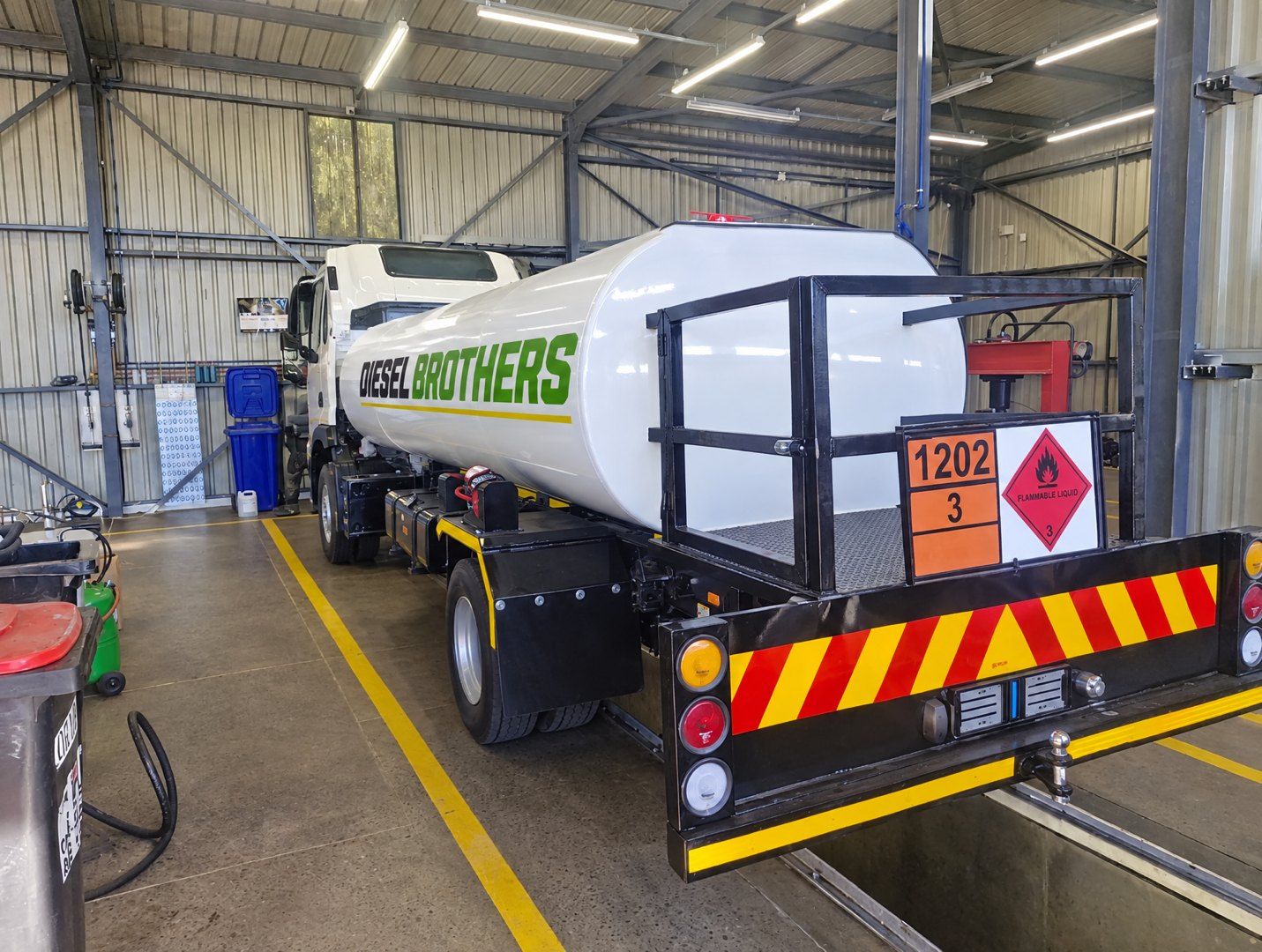 18 000 L Diesel Brothers tanker in the maintenance bay, 1202 flammable-liquid placards at the rear